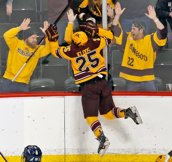Gophers fans celebrate with Justin Kloos after he scored the third Minnesota goal in the first period. ] Minnesota Gophers vs. Robert Morris Colonials