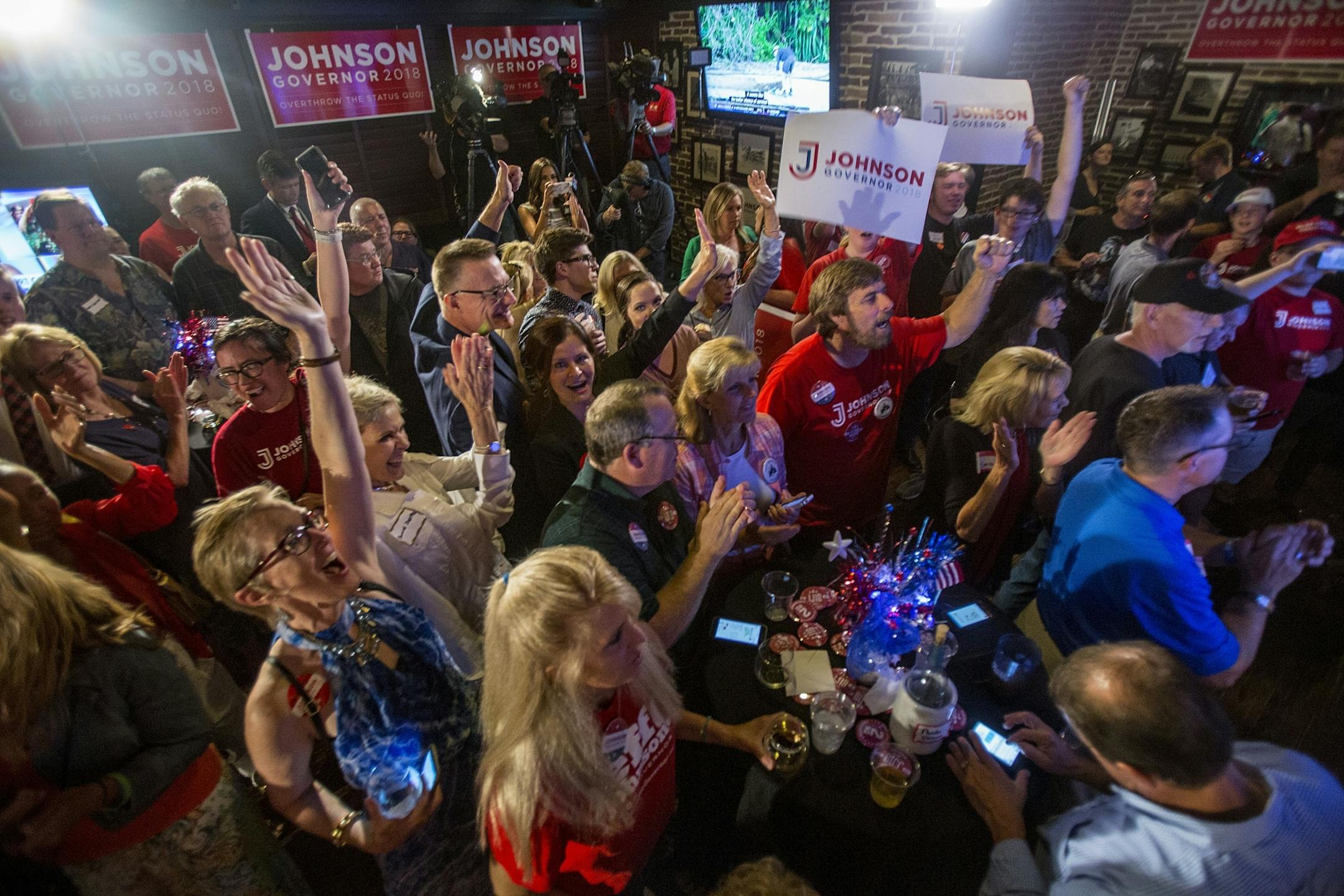 Jeff Johnson supporters cheer as they watch the live polls on the TV. Johnson maintained a healthy lead throughout the night.
