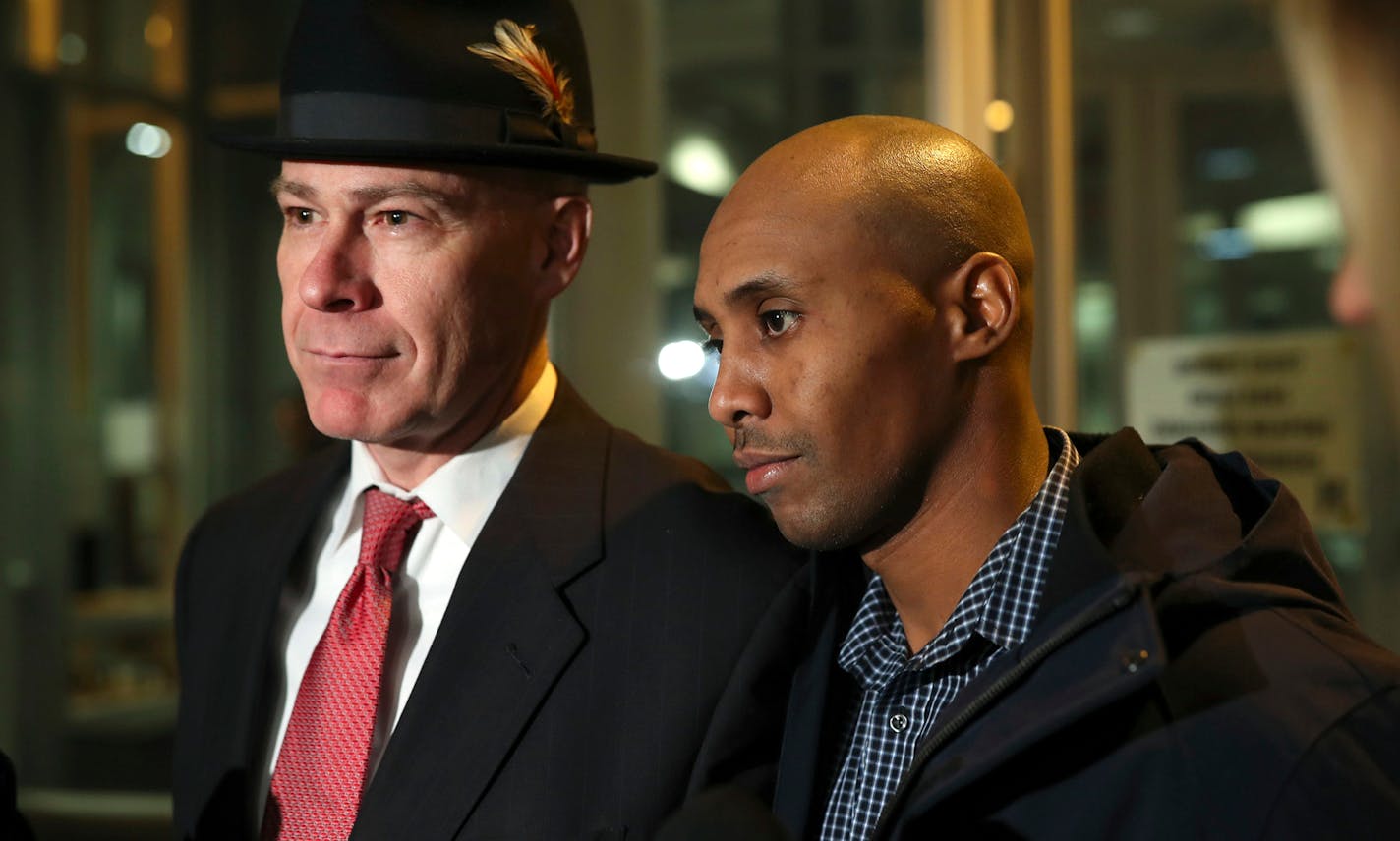 FILE - In this March 21, 2018, file photo, former Minneapolis Police Officer Mohamed Noor leaves the Hennepin County Public Safety Facility with his attorney, Thomas Plunkett, left, after posting bail in Minneapolis. Noor is charged with murder and manslaughter in the July death of Justine Ruszczyk Damond, who had called 911 to report a possible sexual assault behind her home. Police in Minneapolis announced Wednesday, April 4, 2018, new steps to make sure officers use body cameras in the wake o