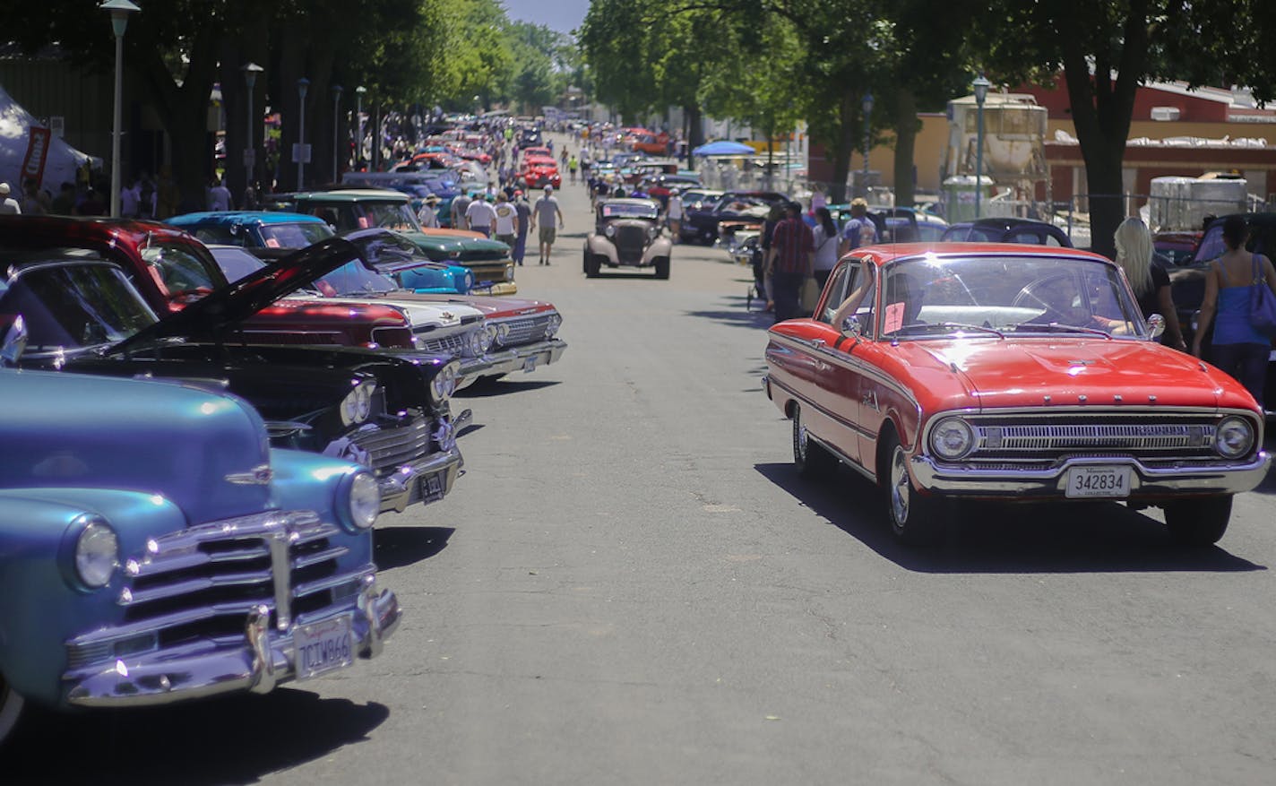 A Ford Falcon, right, makes its way out of the Minneapolis State Fairgrounds at the conclusion of the 2016 "Back to the 50s" street rod exhibition on Sunday, June 19, 2016. ] Timothy Nwachukwu &#xa5; timothy.nwachukwu@startribune.com The Minnesota Street Rod Association concluded 2016 "Back to the 50s" street rod exhibition at the Minnesota State Fairgrounds on Sunday, June 19, 2016. Over 10,000 street rods made in or before 1964 were registered to attend during the three-day event. ] Timothy Nw