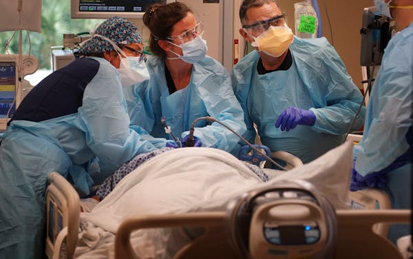 Medical workers at Morton Plant Hospital in Clearwater, Florida work to stabilize a COVID-19 patient Wednesday, August 25, 2021.