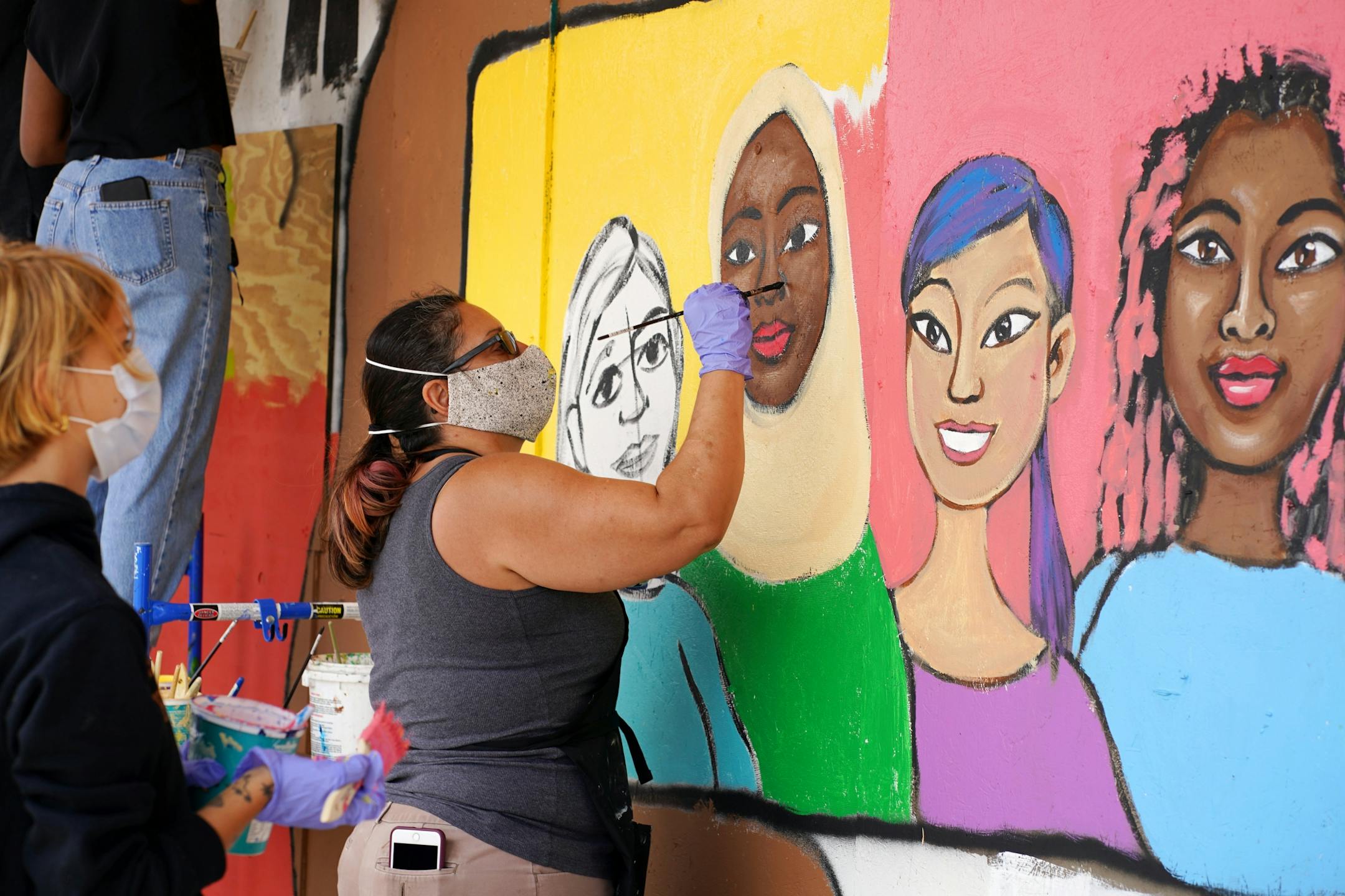 Local artist and muralist Melodee Strong, who along with Kmart organized Saturday's event, painted the outside of the Kmart on Nicollet Saturday morning.