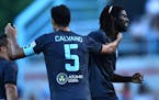 Minnesota United FC defender Tiago Calvano (5) celebrated with forward Ismaila Jome (15) after Jome's first franchise league goal in the second half a