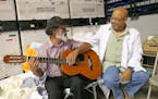 Santos Candelaria plays guitar and sings with Alfredo Guzman, MD VA Doctor from Oxford, Ala., and Natural de Villalba P.R., at the temporary hospital 