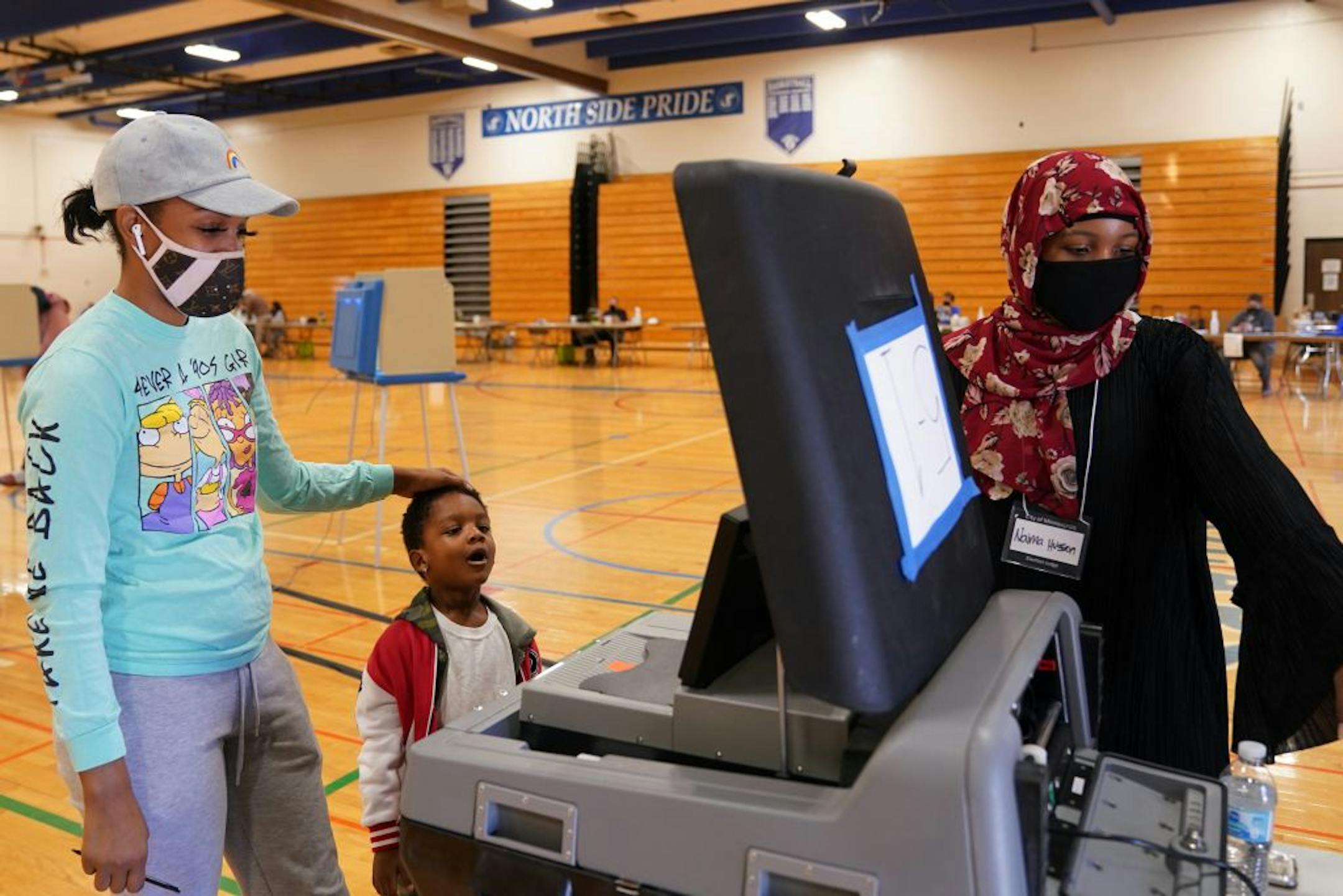Karter Benson, 4, watched as his mom Ceara Hinton cast her ballot at the North High School gymnasium polling location in north Minneapolis on Election Day.