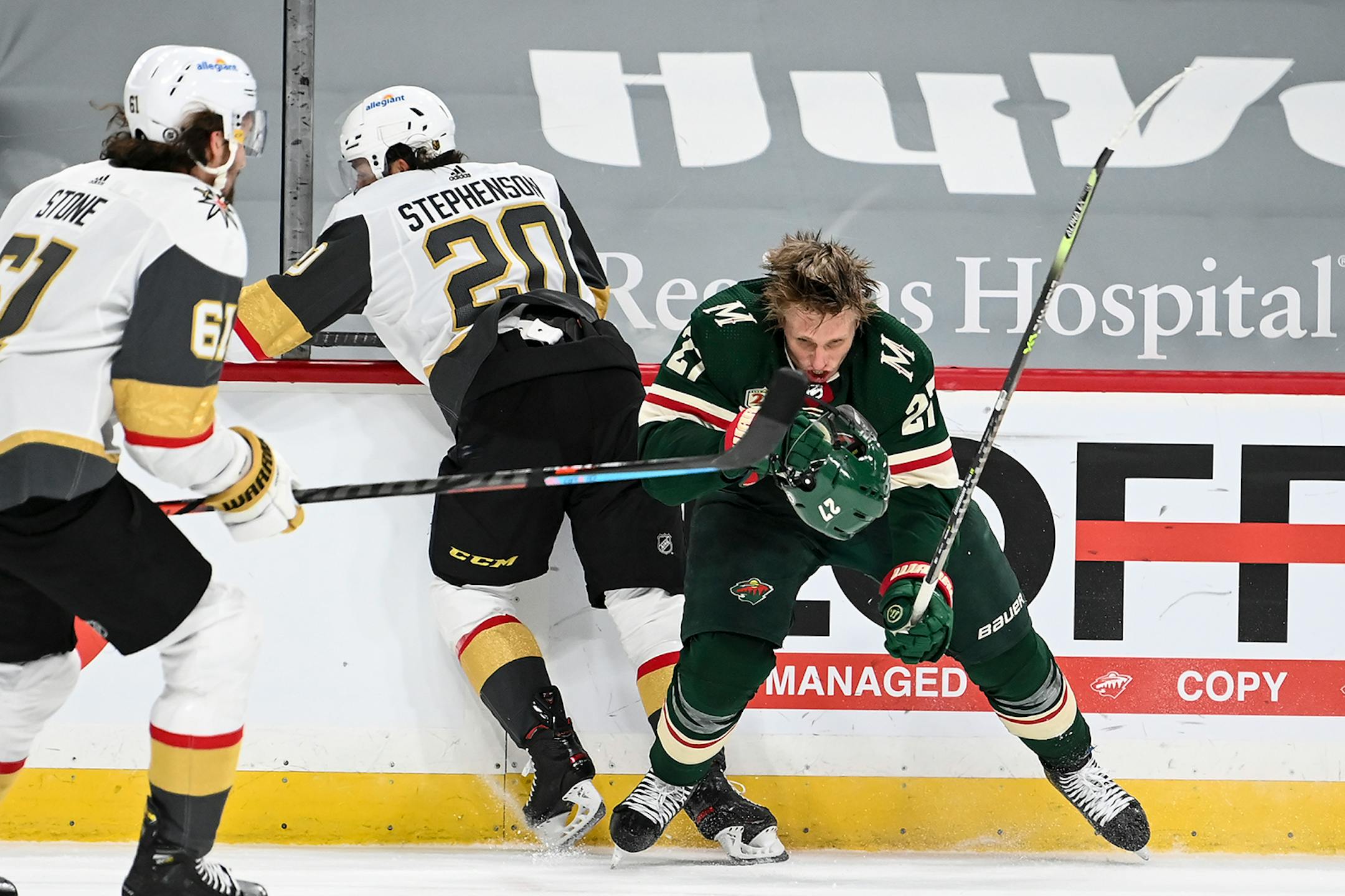 Minnesota Wild center Nick Bjugstad (27) lost his helmet after a hard collision against the boards with Vegas Golden Knights center Chandler Stephenson (20) late in the second period.
