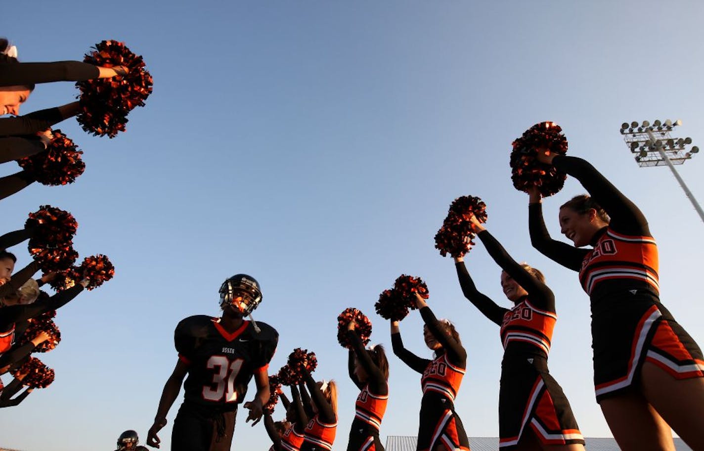 Osseo High School players took the field before the start of a recent game between Osseo and Blaine High Schools in Maple Grove.