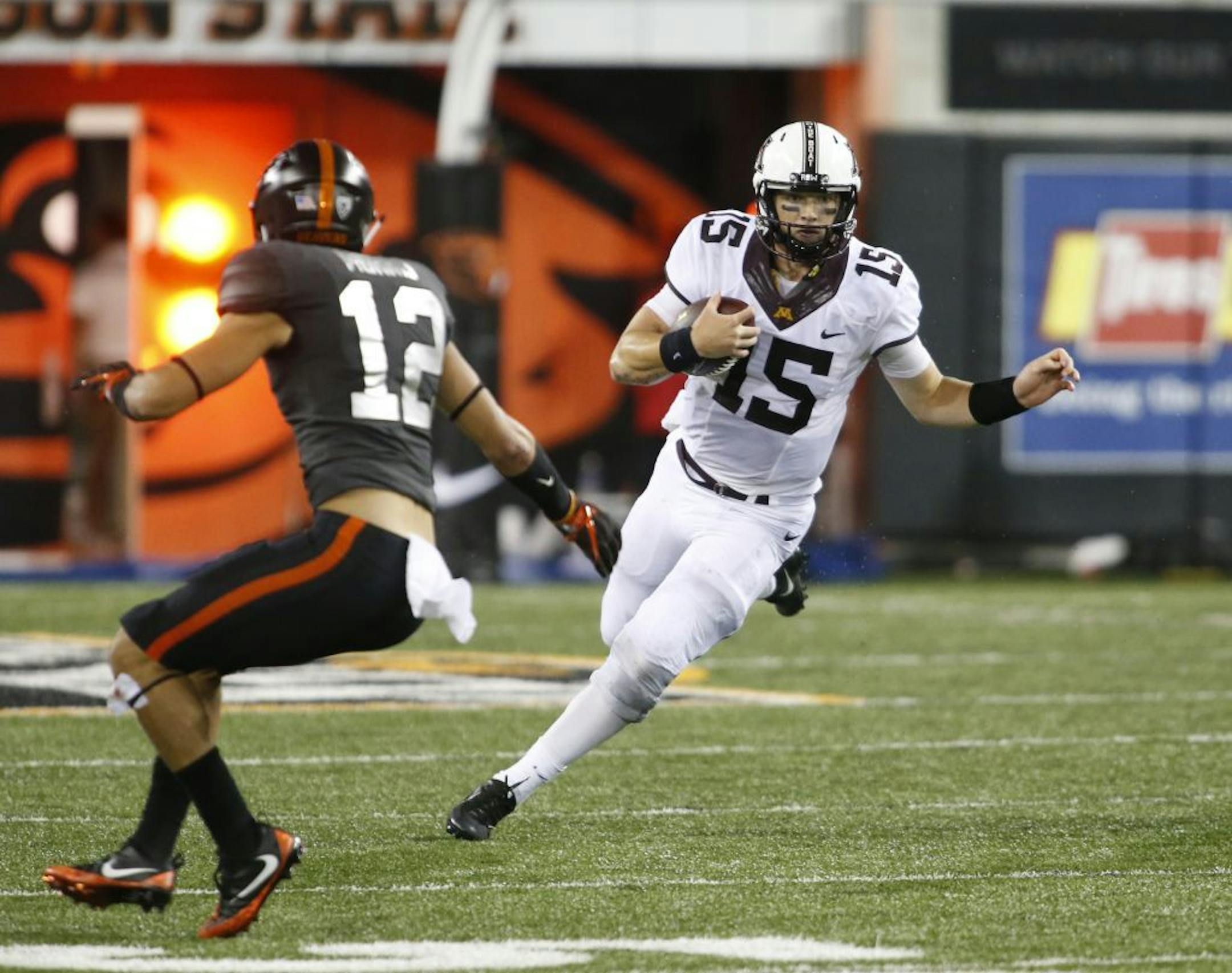 Minnesota quarterback Conor Rhoda (15) tries to get past Oregon State's David Morris during the second half of an NCAA college football game, in Corvallis, Ore., Saturday, Sept. 9, 2017. Minnesota won 48-14.