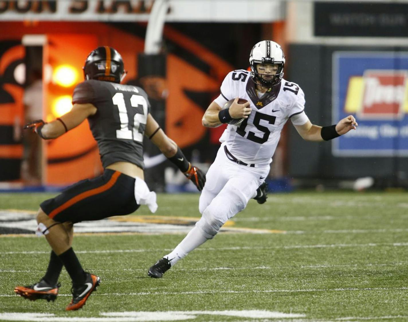 Minnesota quarterback Conor Rhoda (15) tries to get past Oregon State's David Morris during the second half of an NCAA college football game, in Corvallis, Ore., Saturday, Sept. 9, 2017. Minnesota won 48-14.