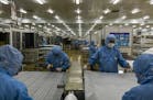 FILE -- Solar panels are assembled at a manufacturing plant in Hefei, China, June 5, 2017. The United States accuses China of swamping the market with