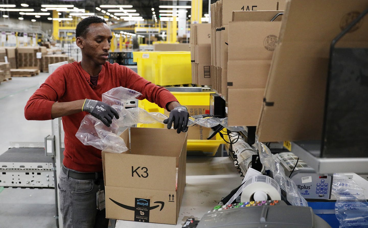 Mohamedamin Budul packed up an order at Amazon. ] ANTHONY SOUFFLE &#xef; anthony.souffle@startribune.com Site managers gave a tour of the Amazon fulfillment center Wednesday, May 9, 2018 in Shakopee, Minn. The center relies on robots to help fill orders more quickly.