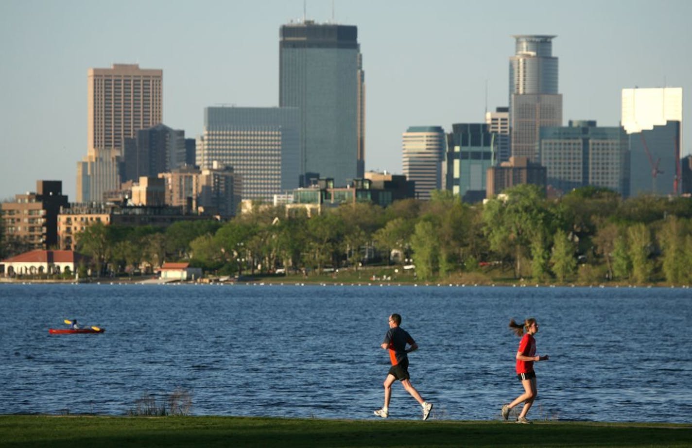 Joggers and a kayaker at Lake Calhoun.