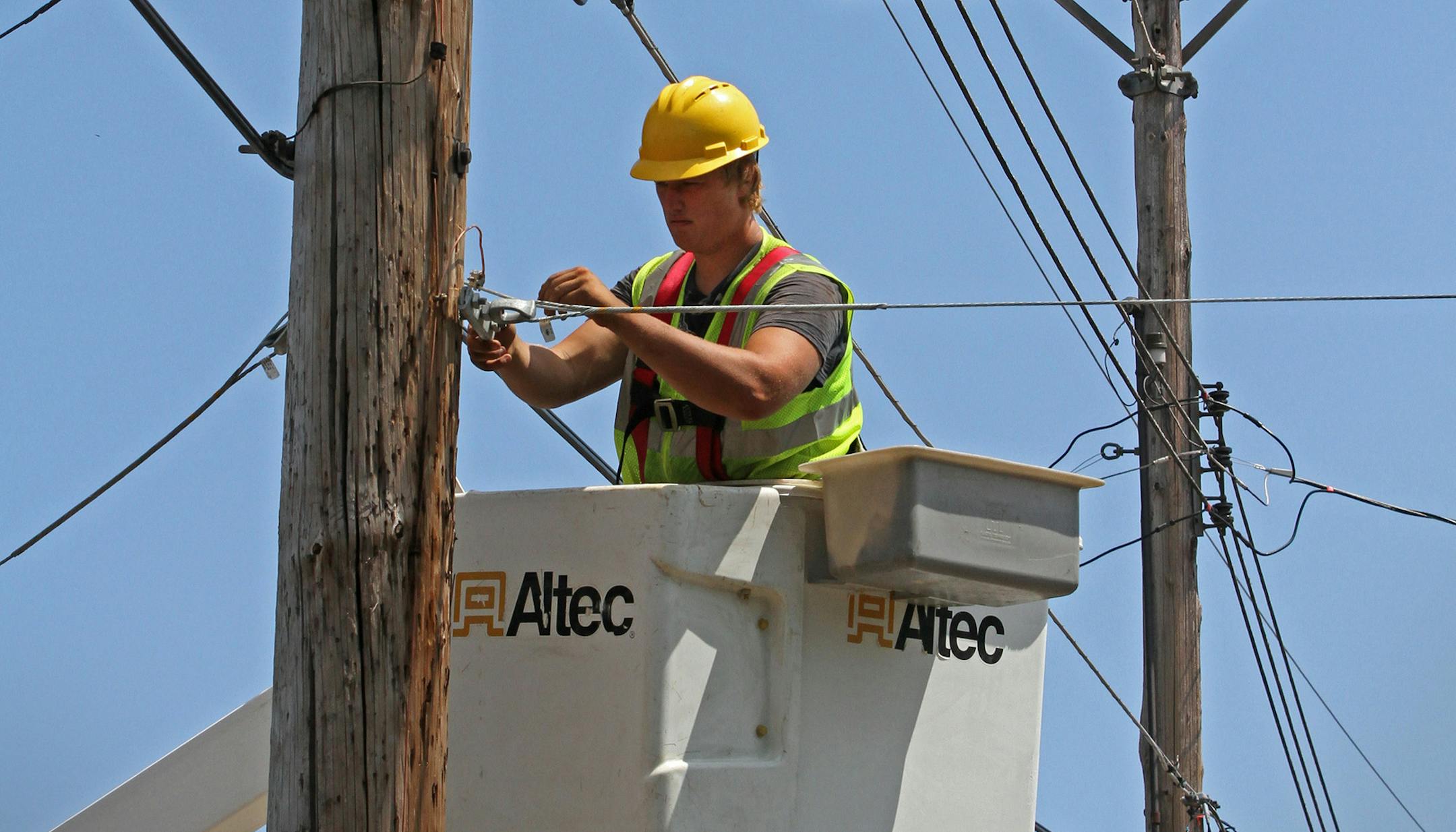 Seth Kern, with Lake States Construction, a sub-contractor of Lake Connections, readied telephone poles in Two Harbors to string stainless steel strand cables from which fiber optic cable will be lashed to on 7/31/12. By the time the communications project is done in 2014 around 2000 miles of fiber optic cable will be strung, connecting customers with broadband internet, video and telephone service. ] Bruce Bisping/Star Tribune bbisping@startribune.com ORG XMIT: MIN2015041415464351