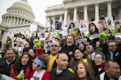 FILE-- Rep. Luis Gutierrez (D-Ill.), center bottom, joins a protest supporting protections for immigrants outside the Capitol in Washington, Dec. 6, 2