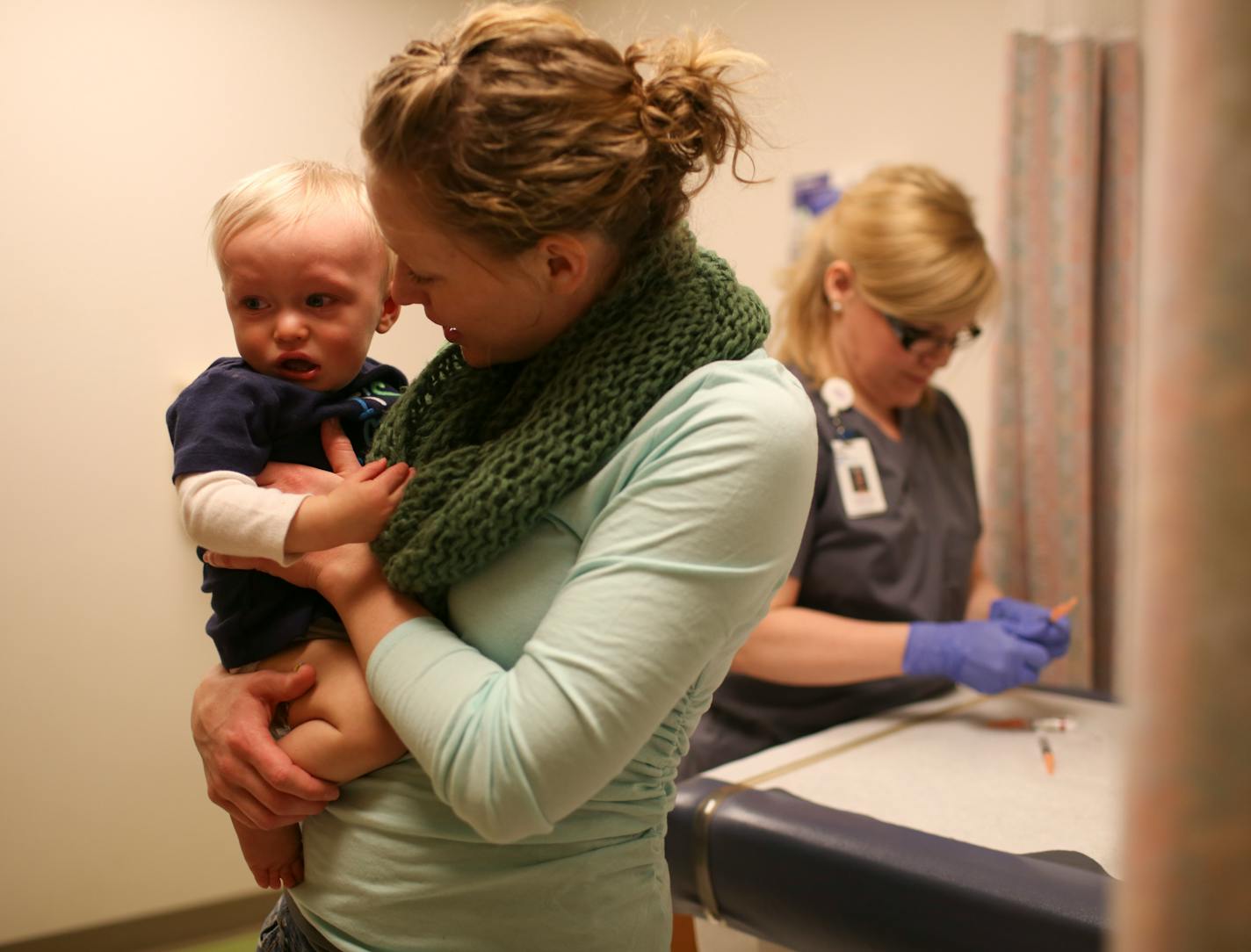 Anna Calcote held her son, Weston, after he braved his 12-month series of shots, including the MMR vaccine, at the Children's Specialty Center at Children's Hospital in Minneapolis Thursday afternoon.