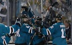 San Jose Sharks right wing Joonas Donskoi, from Finland, center, celebrates with teammates after scoring the winning goal during overtime of Game 3 of