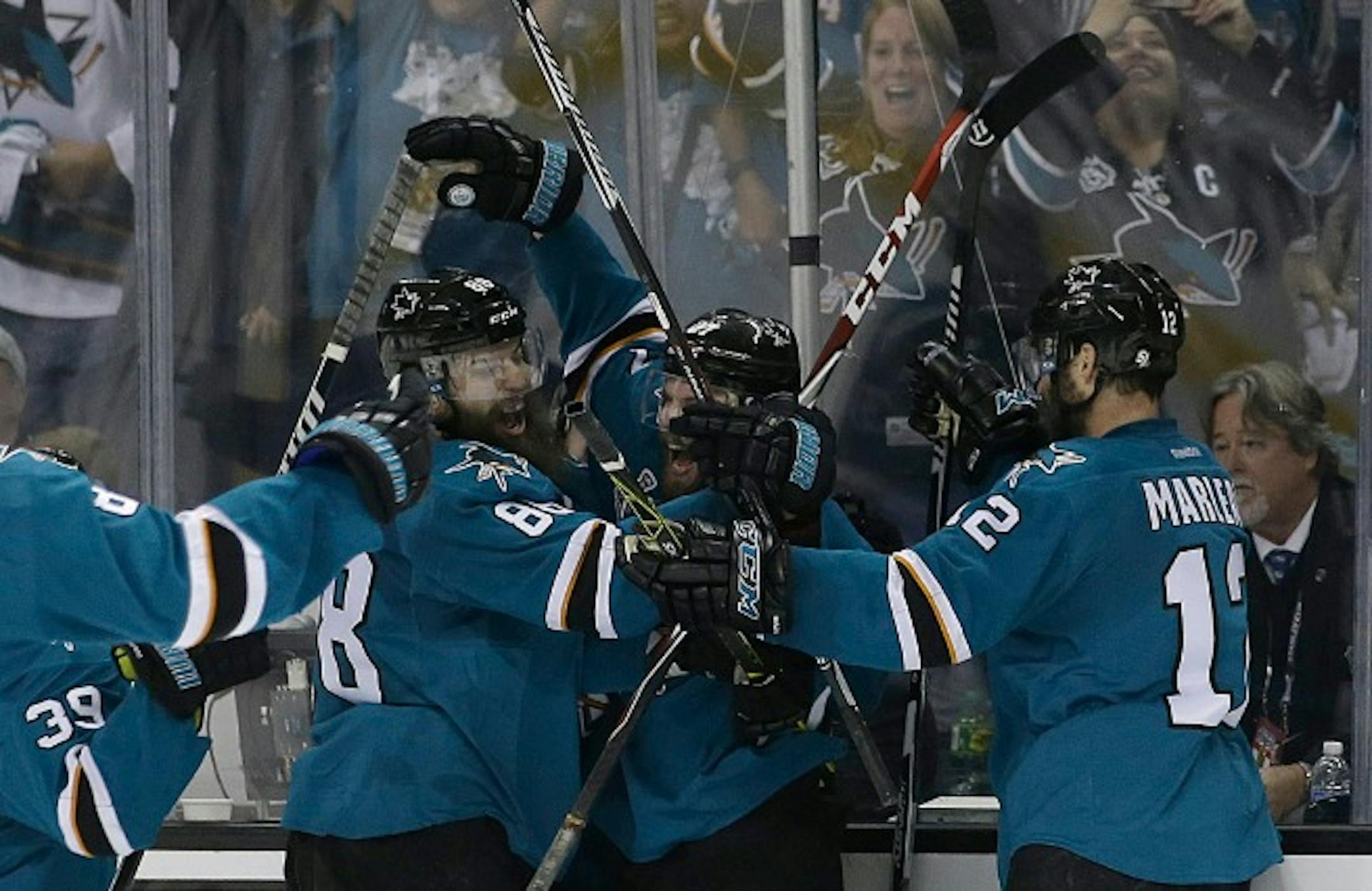 San Jose Sharks right wing Joonas Donskoi, from Finland, center, celebrates with teammates after scoring the winning goal during overtime of Game 3 of the NHL hockey Stanley Cup Finals against the Pittsburgh Penguins in San Jose, Calif., Saturday, June 4, 2016. The Sharks won 3-2. (AP Photo/Marcio Jose Sanchez)