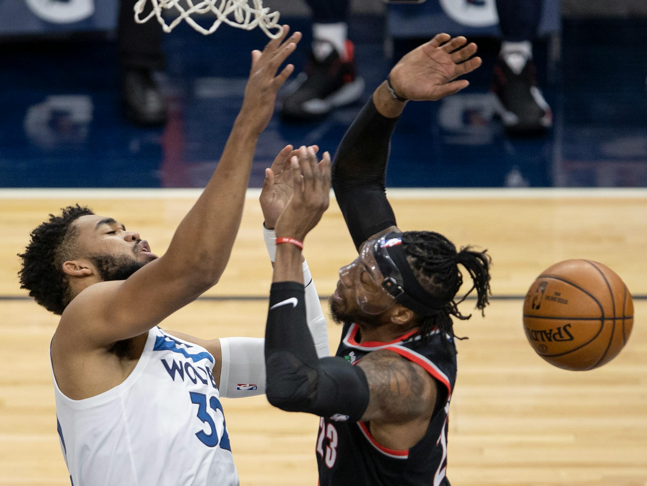 Karl-Anthony Towns (32) of the Minnesota Timberwolves was fouled by Robert Covington (23) of the Portland Trailblazers in the first quarter.
