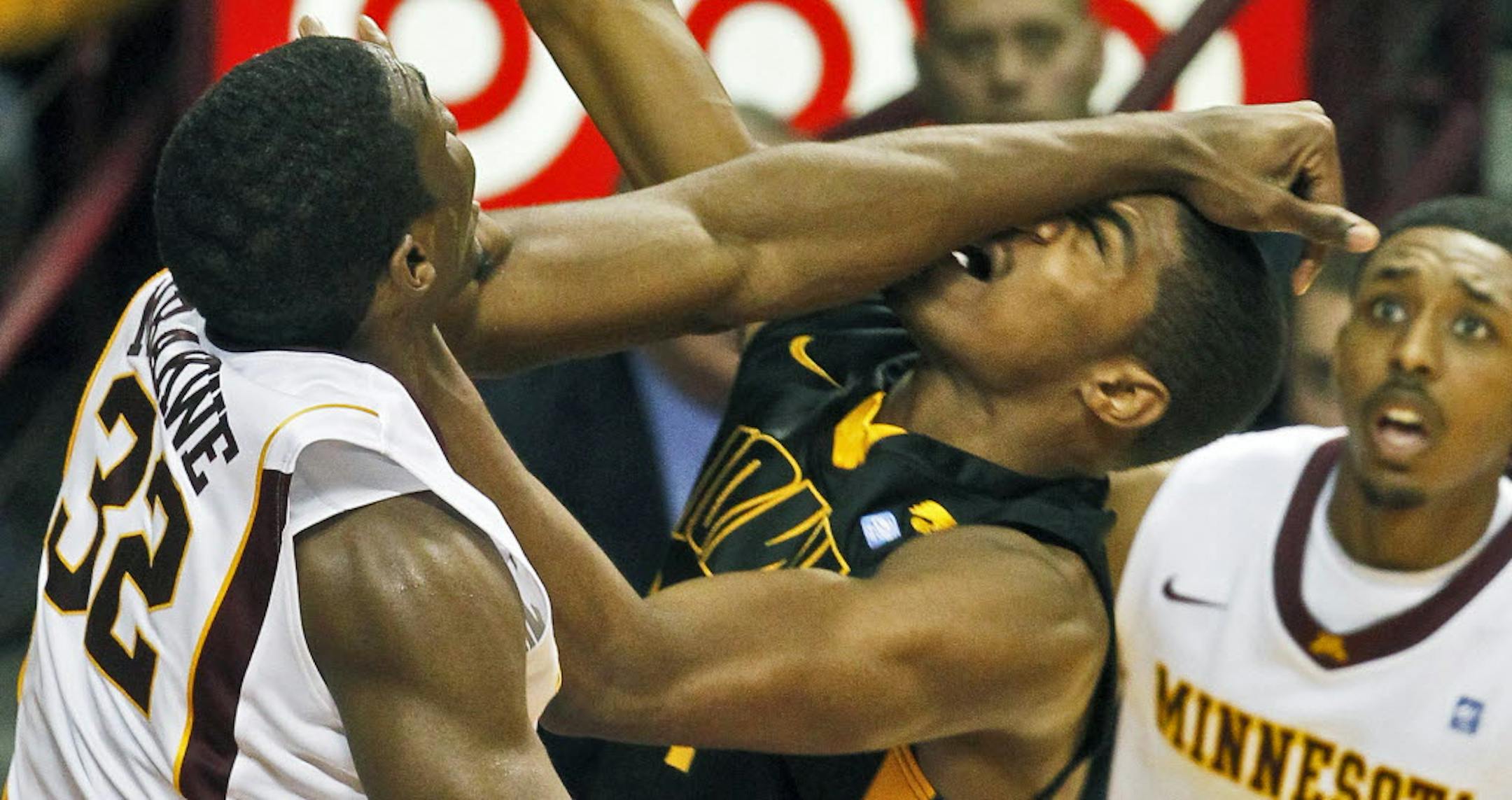 The Gophers' Trevor Mbakwe and Iowa's Melsahn Basabe battled for a rebound during Minnesota's 69-59 victory at Williams Arena on Sunday.