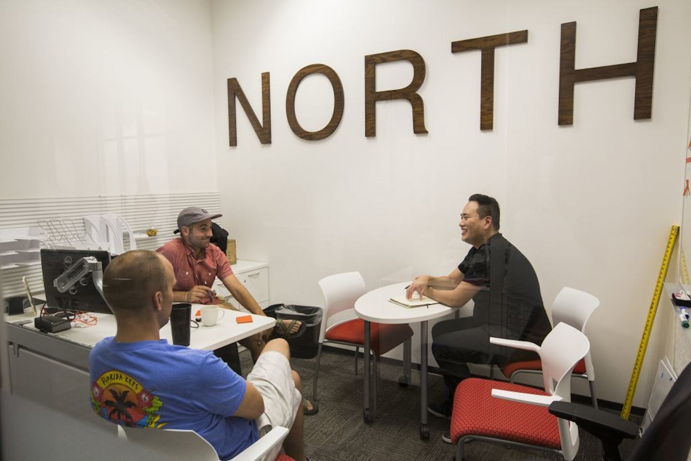 Mike Stone, right, the CEO of MakersKit, talks with Ryan Broshar, top left, Techstar's managing director and Brett Brohl, Techstar's entrepreneur in residence during a meeting.