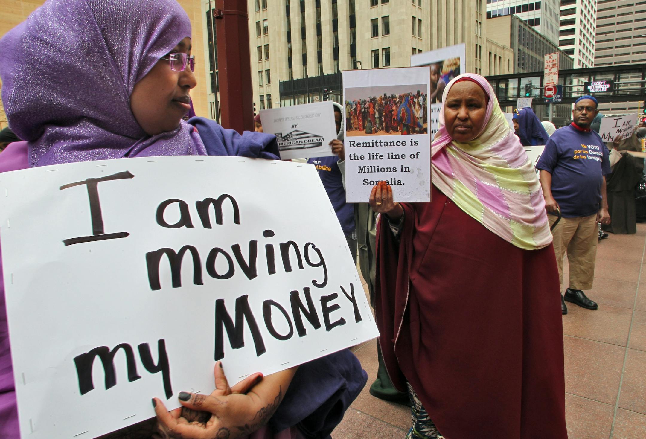 Somalis upset with Wells Fargo Bank for its refusal to handle some of the community money transfers to their homeland demonstrated and closed down personal accounts at the downtown Minneapolis bank Friday afternoon. Members of the Aztec Indian Dance Troupe and protest group Occupy MN also joined in the demonstration. (MARLIN LEVISON/STARTRIBUNE(mlevison@startribune.com