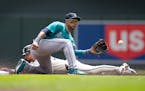 Eddie Julien of the Twins steals second base in the first inning Thursday, beating the throw to Mariners second baseman Jorge Polanco.