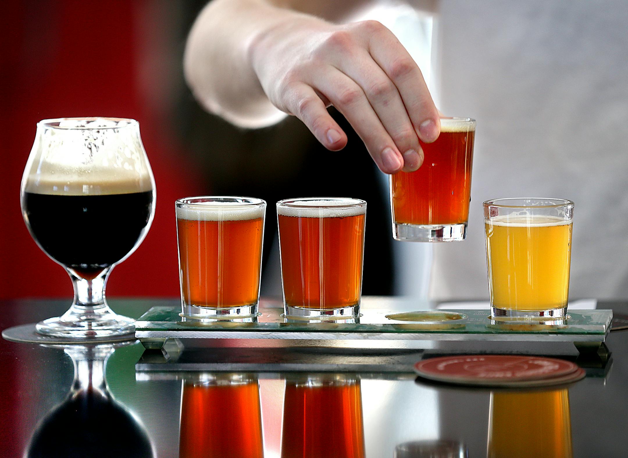 At an outing planned by GetKnit, participants tasted flights of Tin Whiskers beers after yoga class. Burning calories by exercising encourages some jocks to imbibe.