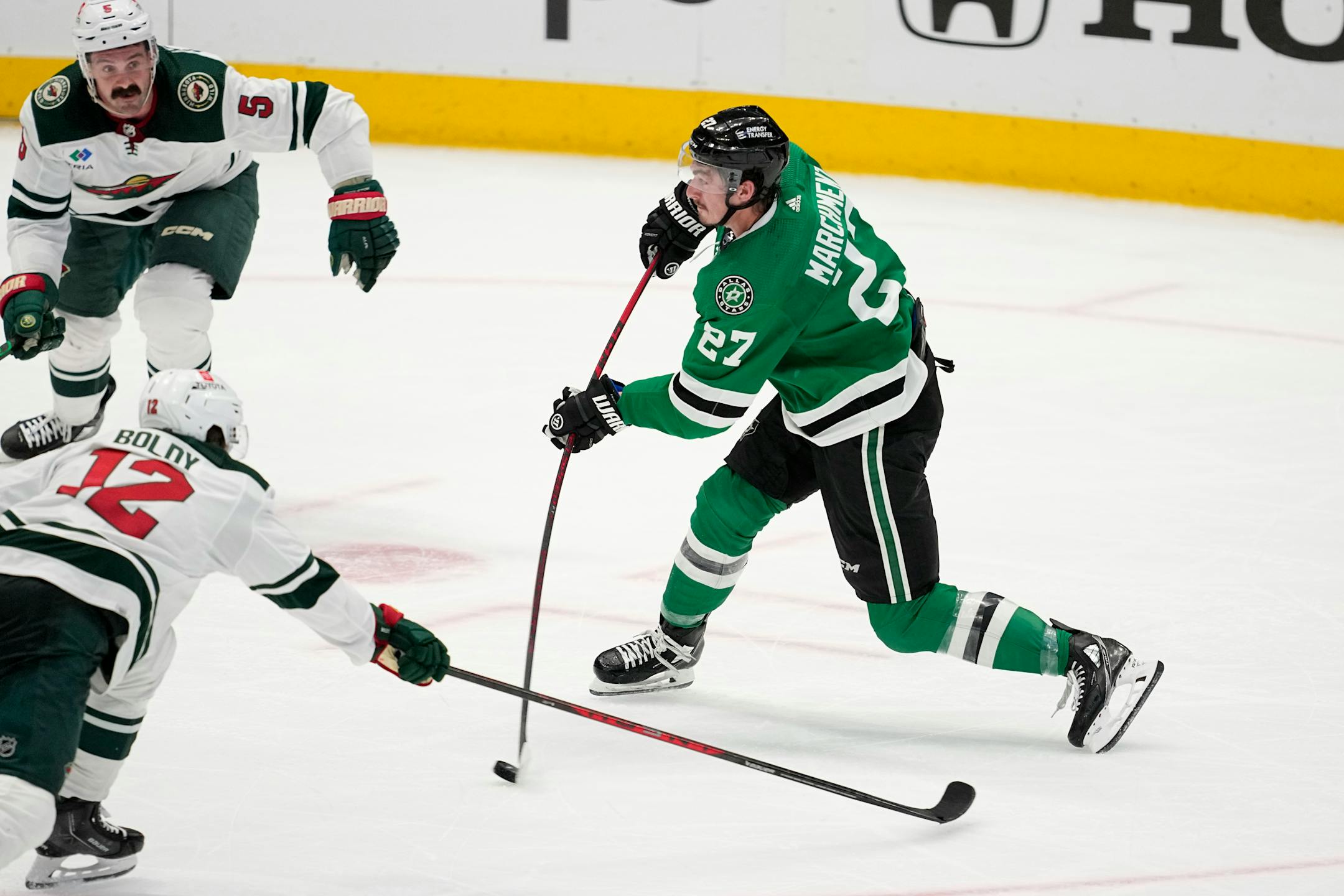 Dallas Stars left wing Mason Marchment (27) takes a shot at the net between Minnesota Wild's Matt Boldy (12) and Jake Middleton (5) in the third period of Game 1.