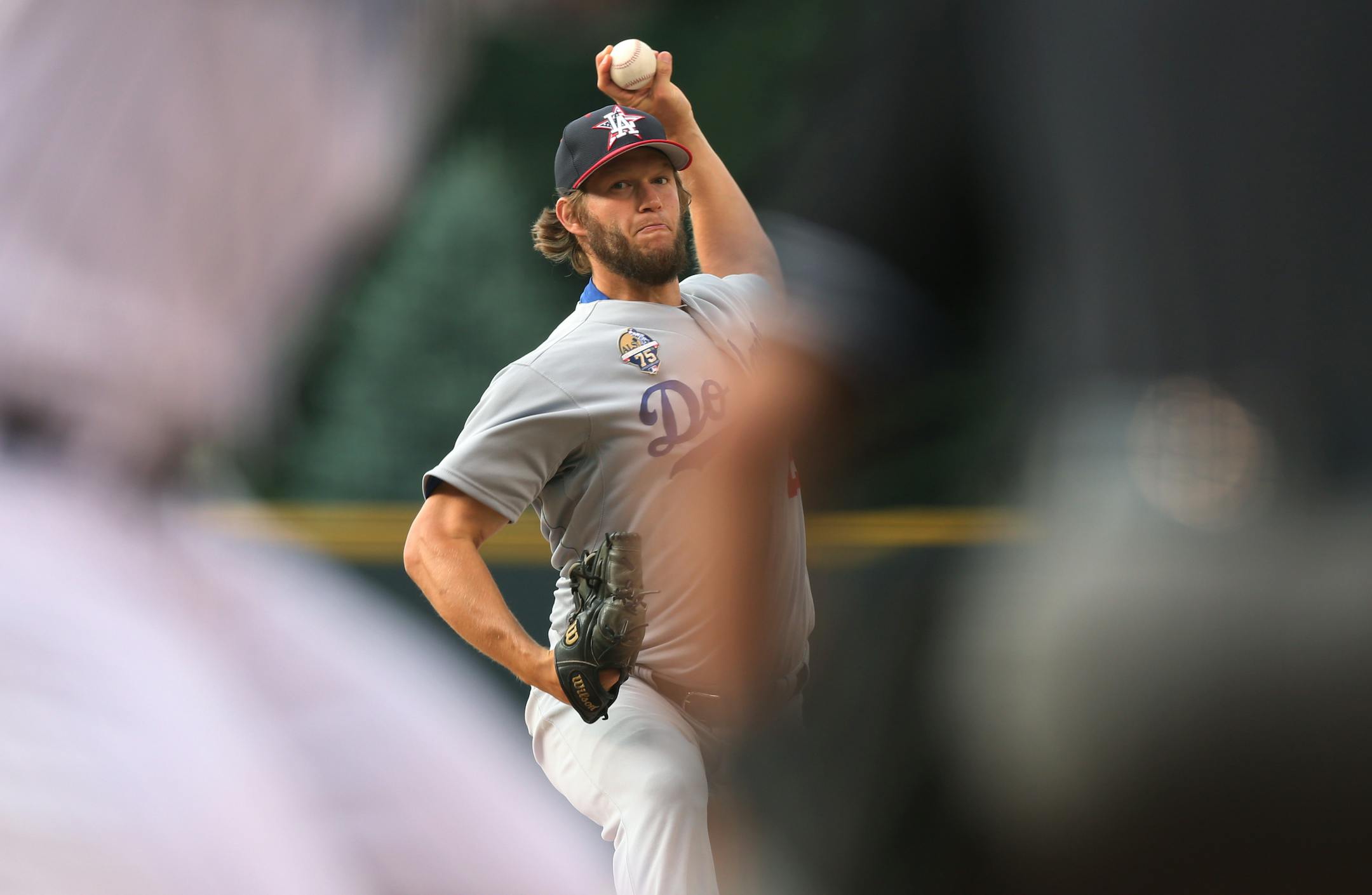 Los Angeles Dodgers starting pitcher Clayton Kershaw works against the Colorado Rockies in the first inning of a baseball game in Denver on Friday, July 4, 2014. (AP Photo/David Zalubowski)