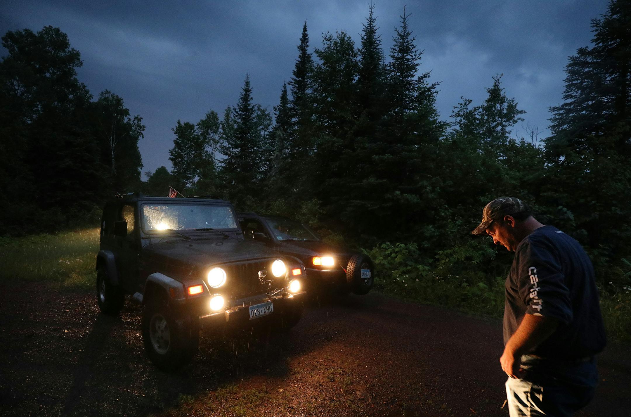 Scott Benalken took pause along with the rain as stopped briefly while driving his Jeep Wrangler down what would be the Border to Border "touring route" on existing roads to welcome four-wheel drive tourists in the summer. ] ANTHONY SOUFFLE ï anthony.souffle@startribune.com Scott Benalken and fellow 4x4 aficionados drove part of what would be the Border to Border "touring route" on existing roads to welcome four-wheel drive tourists in the summer Wednesday, July 7, 2018 near Grand Marais, M