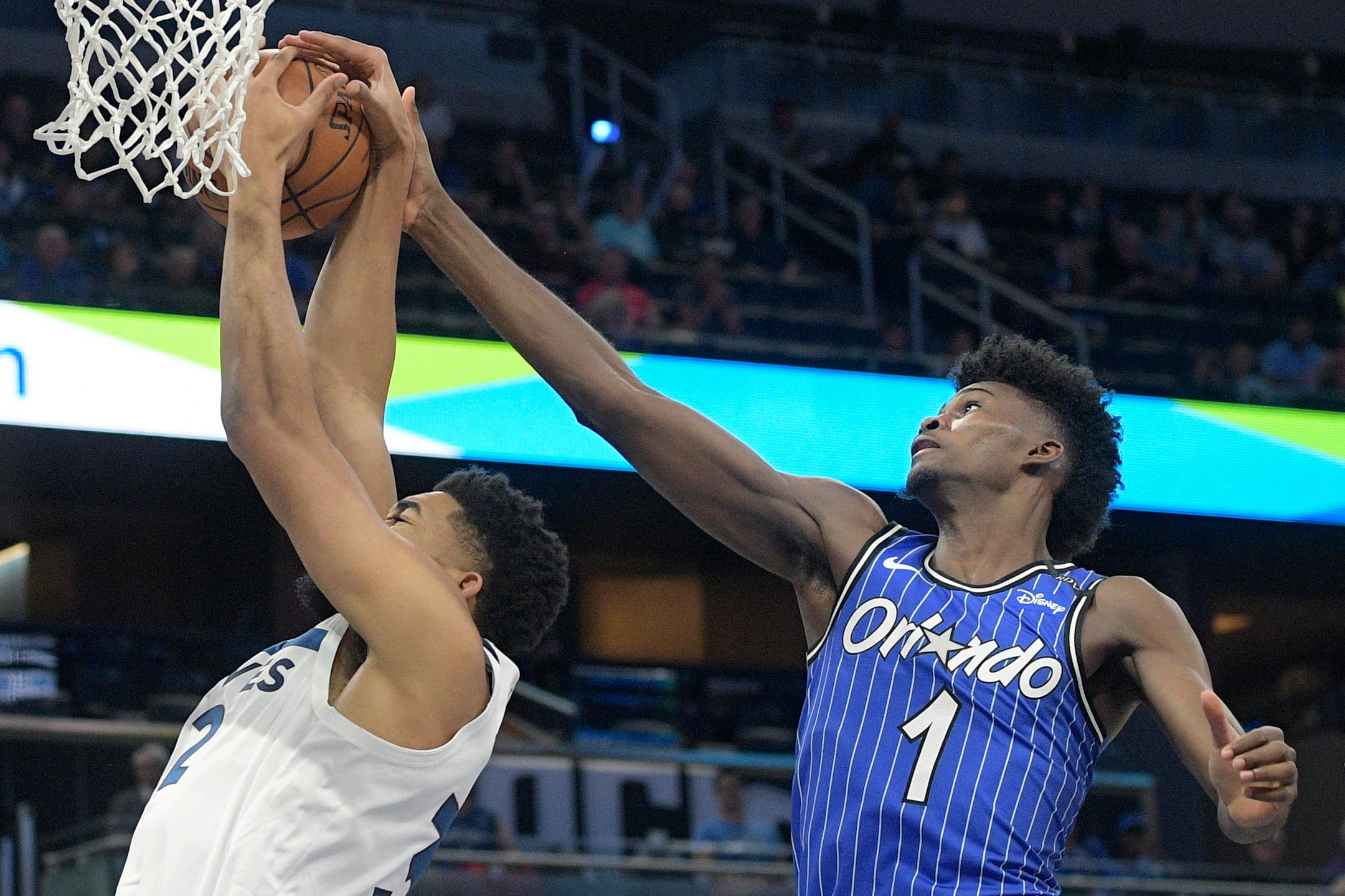 Magic forward Jonathan Isaac blocks a shot by Timberwolves center Karl-Anthony Towns