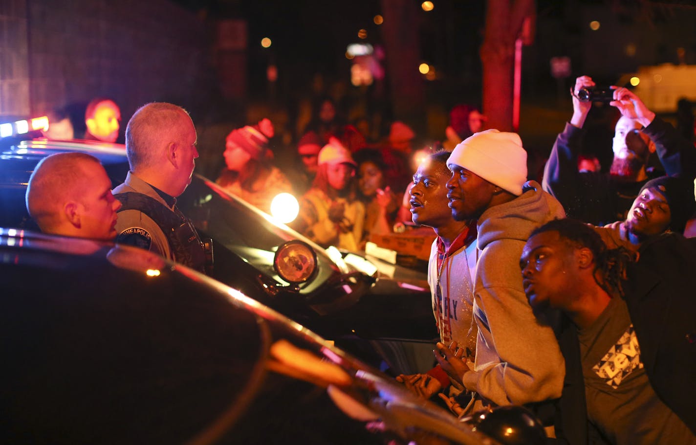 Demonstrators chanted at Minneapolis Police Officers at the side entrance to the 4th Precinct station on Morgan Ave. N. Sunday night in Minneapolis. ] JEFF WHEELER &#xef; jeff.wheeler@startribune.com After a man was shot by Minneapolis police early Sunday morning, Black Lives Matters and others protested Sunday night at the Minneapolis Police 4th Precinct station on Plymouth Ave. N.