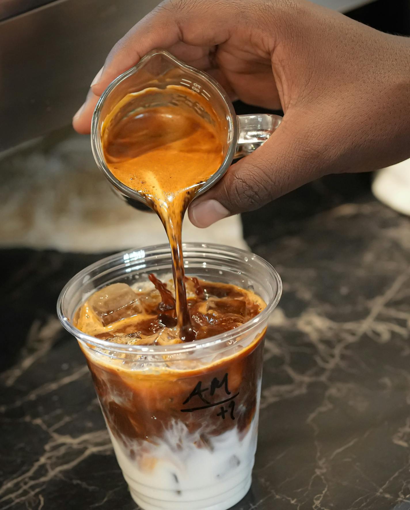 Mohamed Ali made a carmel latte at Fawkes Alley Friday, Sept. 29, 2023 Minneapolis, Minn. Fawkes Alley Coffee opened in July and was established by volunteers to raise money for the Futsal Society, a league for youth playing a sport that's like soccer on a smaller scale. ] GLEN STUBBE • glen.stubbe@startribune.com