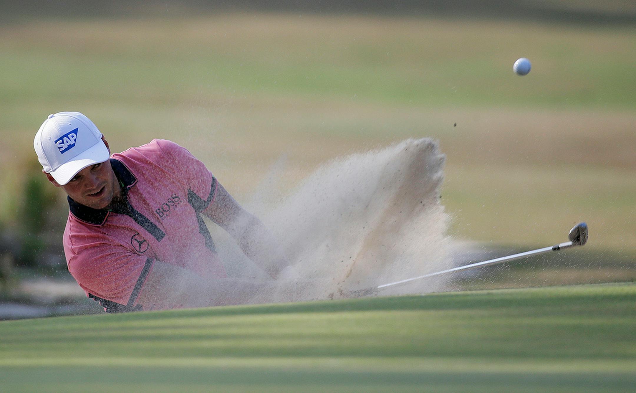 Martin Kaymer, of Germany, hits out of the bunker on the 10th hole during the third round of the U.S. Open golf tournament in Pinehurst, N.C., Saturday, June 14, 2014.