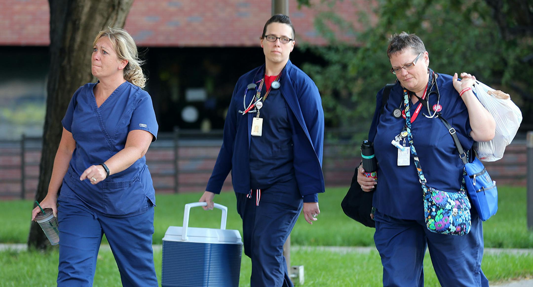Shawn Deitz left, Melissa Zafke, and Donna VanStralen all nurse at Abbott Northwestern walked out of the hospital at the end of there shift at 7am joining other nurse on the Pickett line Sunday June 19, 2016 in Minneapolis, MN.