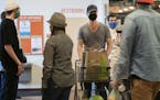 Kyle Hale finished his shopping at Linden Hills Coop. Starting at 5 p.m. Tuesday, shoppers in Minneapolis will be required to wear masks.