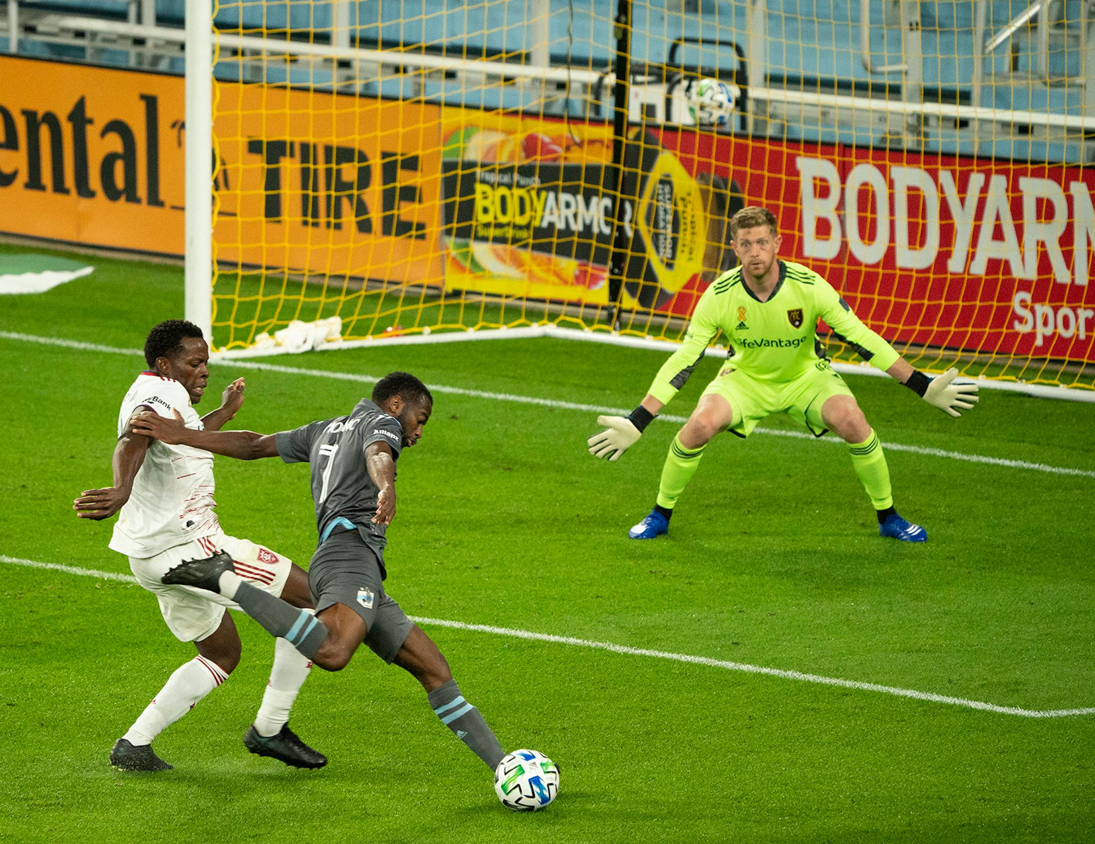 Minnesota United midfielder Kevin Molino (7) took a second half shot on Real Salt Lake goalkeeper Zac MacMath (18) as he was defended closely by Real Salt Lake's Nedum Onuoha (14).