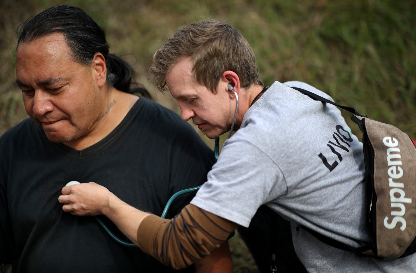 Lewis Simpler a member of a team of nurses with Livio Health Group took the vital signs of Anthony Nichols 52, at the large homeless camp on Monday in Minneapolis. Nichols said that he has a heart condition and had not been taking his medicine; he was later transported to local hospital by ambulance. Nichols said that he had been staying at the camp for only two days.