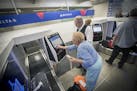 Delta Airlines ticket agent Chris Morris helped guide travelers through their new self-service bag drop machine at Minneapolis-St. Paul International 