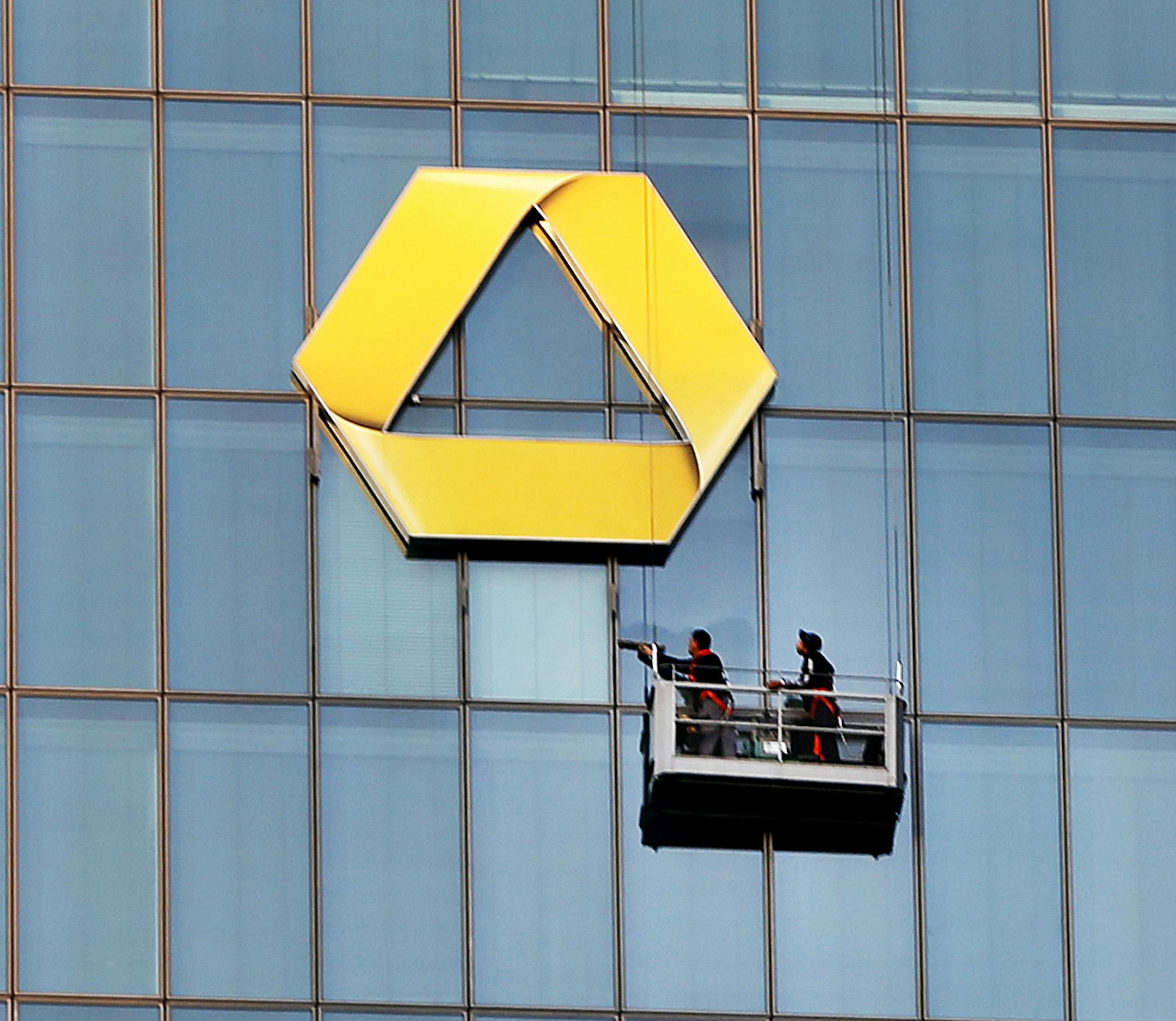 FILE - In this Sept. 23, 2016 photo window cleaners work at the logo of the Commerzbank building in Frankfurt. Shares in Deutsche Bank and Commerzbank have risen after news media reports that Deutsche Bank’s top management has agreed to hold preliminary talks about a possible merger. (AP Photo/Michael Probst, file)