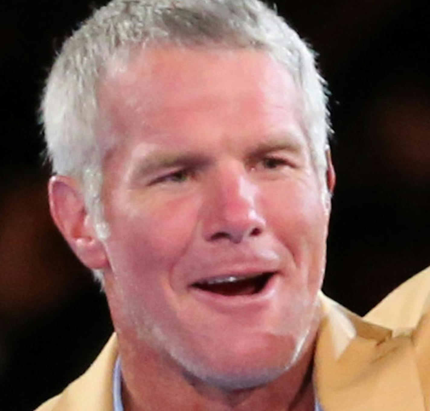 Brett Favre waves after receiving his gold jacket at the Pro Football Hall of Fame enshrinees' dinner, Thursday, Aug. 4, 2016, in Canton, Ohio. (Scott Heckel/The Canton Repository via AP)