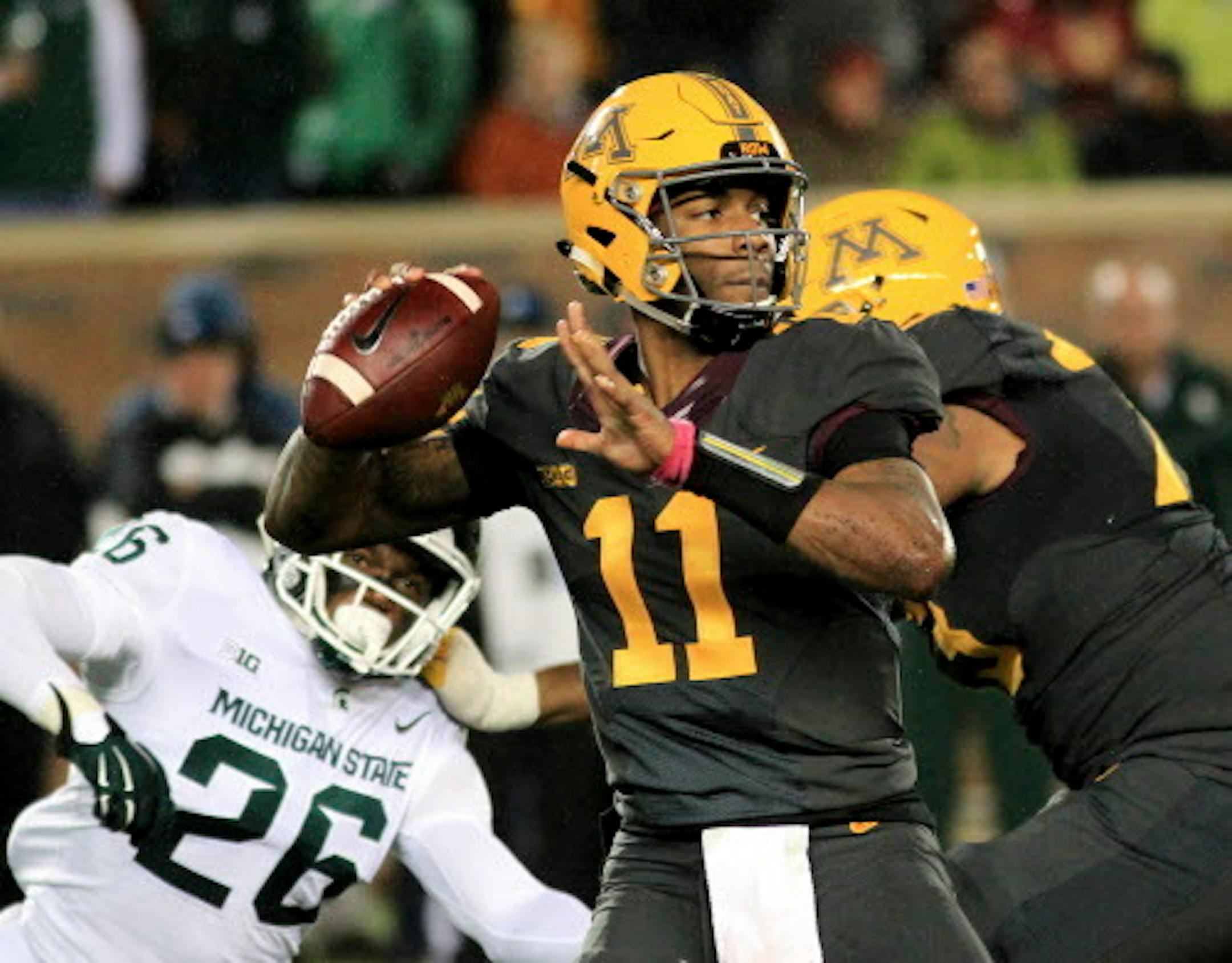 Minnesota quarterback Demry Croft (11) looks to pass against Michigan State during the third quarter of an NCAA college football game on Saturday, Oct. 14, 2017, in Minneapolis. Michigan State defeated Minnesota 30-27. (AP Photo/Andy Clayton-King)