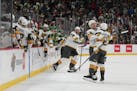 Vegas winger Jonathan Marchessault, right, is congratulated by center Ivan Barbashev after Marchessault scored an empty-net goal in overtime to beat t