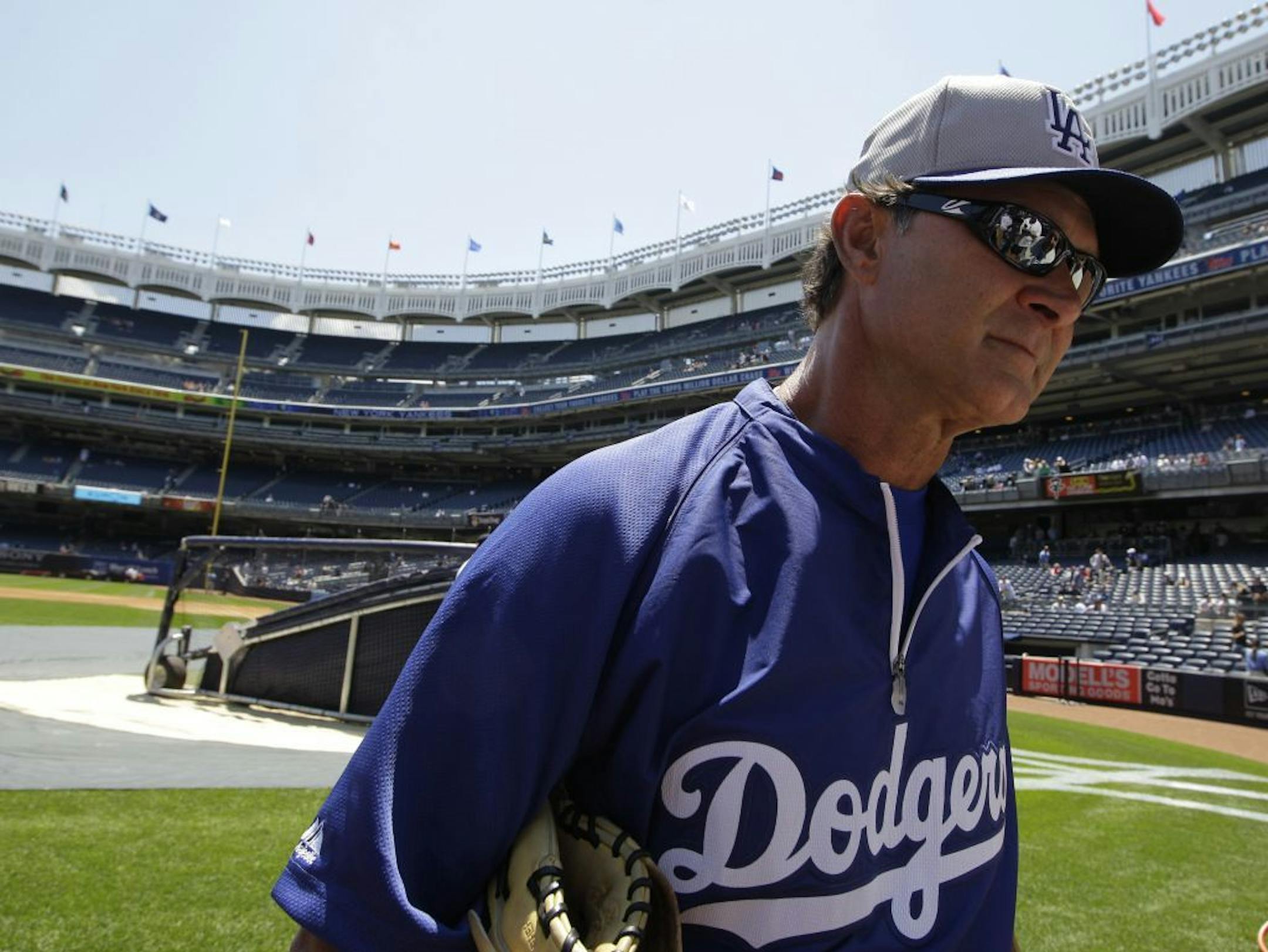 Los Angeles Dodgers manager Don Mattingly walks on the field before a baseball game against the New York Yankees Wednesday, June 19, 2013, in New York.