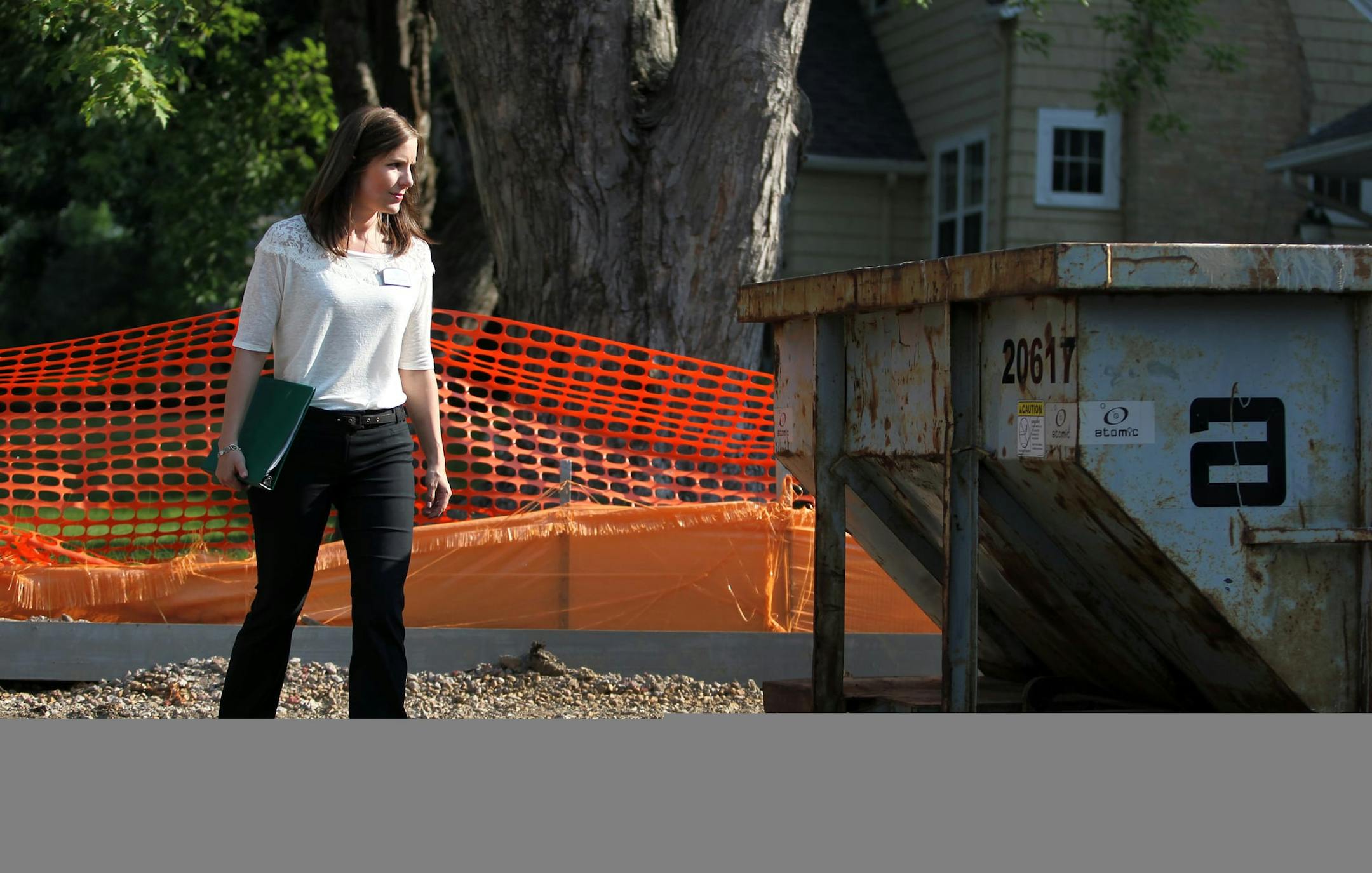 Residential Redevelopment Coordinator for the City of Edina, Cindy Larson, examines a new home construction site in Edina, Minn., on Thursday, July 11, 2013. Larson is a mediator between home builders and neighbors. "My job is part construction, part counselor," she said. ] (ANNA REED/STAR TRIBUNE) anna.reed@startribune.com (cq)