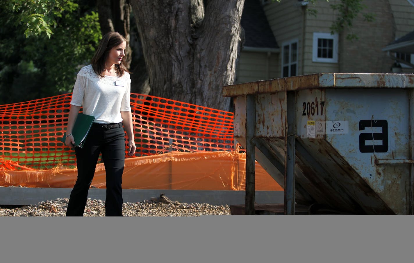 Residential Redevelopment Coordinator for the City of Edina, Cindy Larson, examines a new home construction site in Edina, Minn., on Thursday, July 11, 2013. Larson is a mediator between home builders and neighbors. "My job is part construction, part counselor," she said. ] (ANNA REED/STAR TRIBUNE) anna.reed@startribune.com (cq)