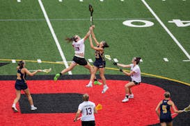 Lakeville South midfielder Tori Tschida (19) and Prior Lake midfielder Abby Grove (23) jump for the ball in the girls lacrosse state championship game