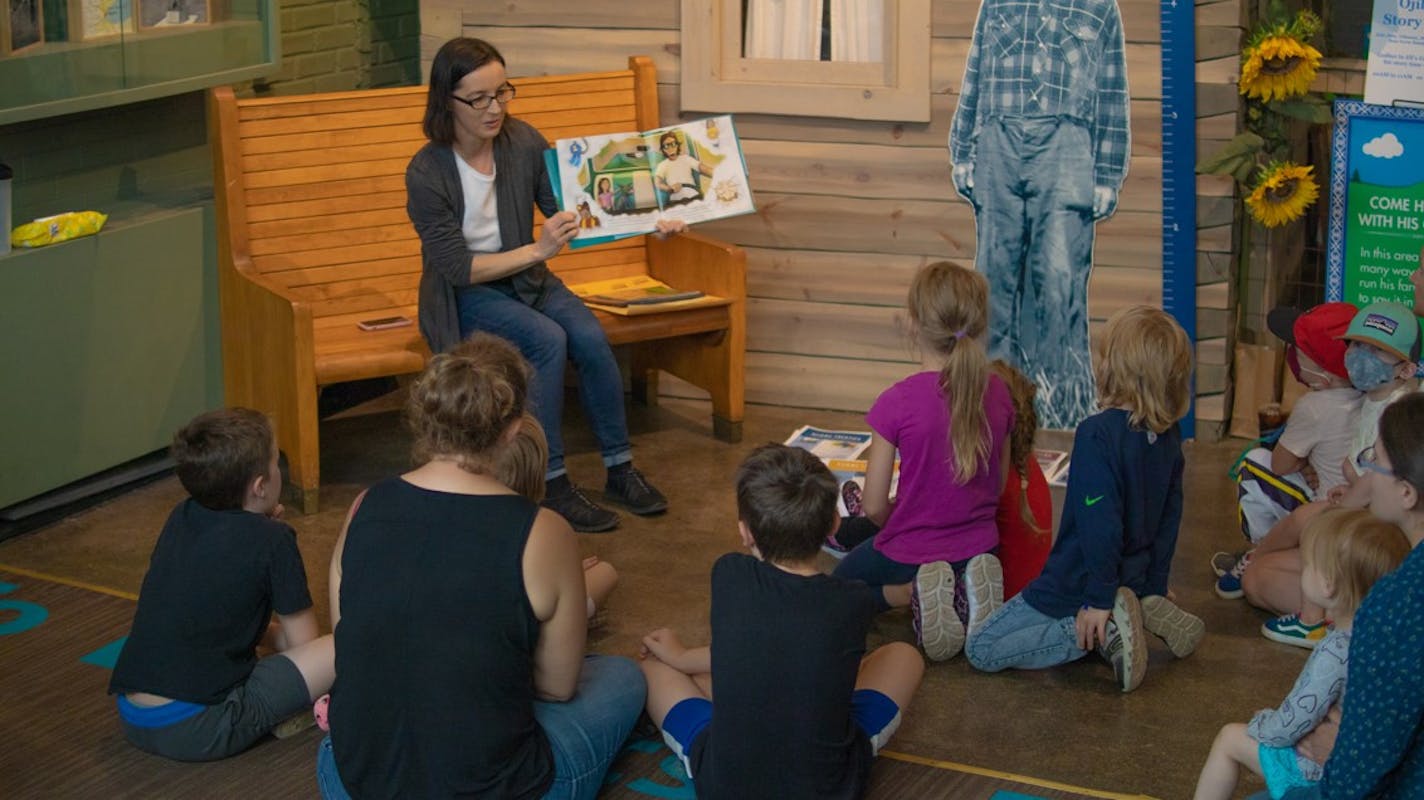 Storyteller Abby Johnson reads to children during Ojibwe Storytime at the Duluth Depot. The weekly event not only introduces children to Ojibwe traditions and culture, it highlights a growing catalog of children's literature from local authors.