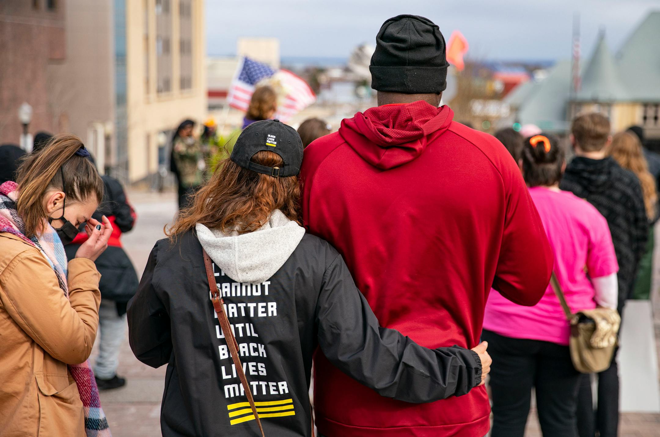 A protestor comforted her friend as he grew emotional listening to the song "Lean on Me" during the protest on Wednesday.