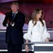 Melania Trump, wife of Republican Presidential Candidate Donald Trump walks to the stage as Donald Trump applaudss during the opening day of the Repub